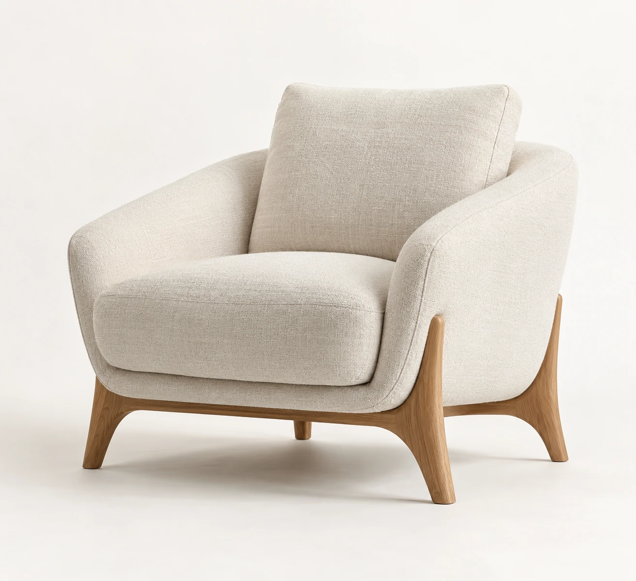 Cream upholstered armchair on a pale studio background